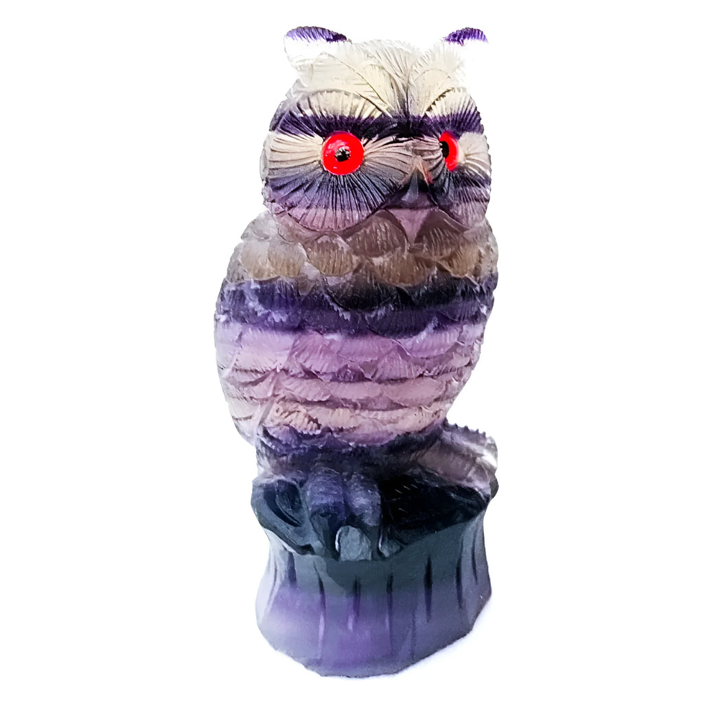 Hand carved purple fluorite owl ornament showing detailed carving and natural colour variation