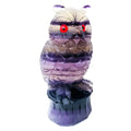 Hand carved purple fluorite owl ornament showing detailed carving and natural colour variation