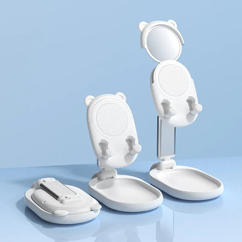 Blue foldable mobile phone holder with mirror holding an iPhone on a desk