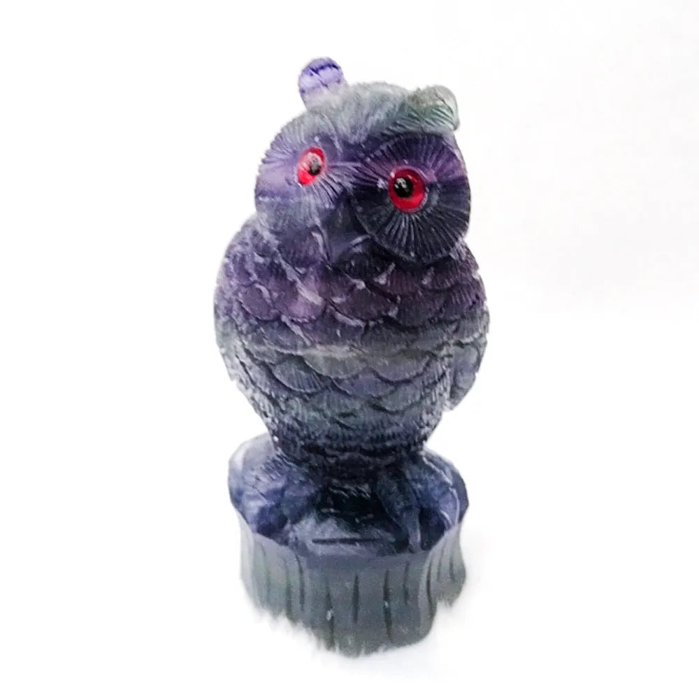 Hand carved purple fluorite owl ornament showing detailed carving and natural colour variation