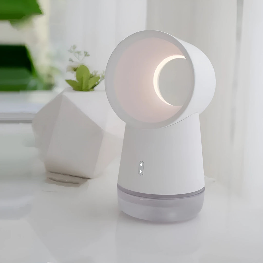 White desktop humidifier with leafless fan and 300ML water tank on a desk, emitting cool mist from single fog outlet