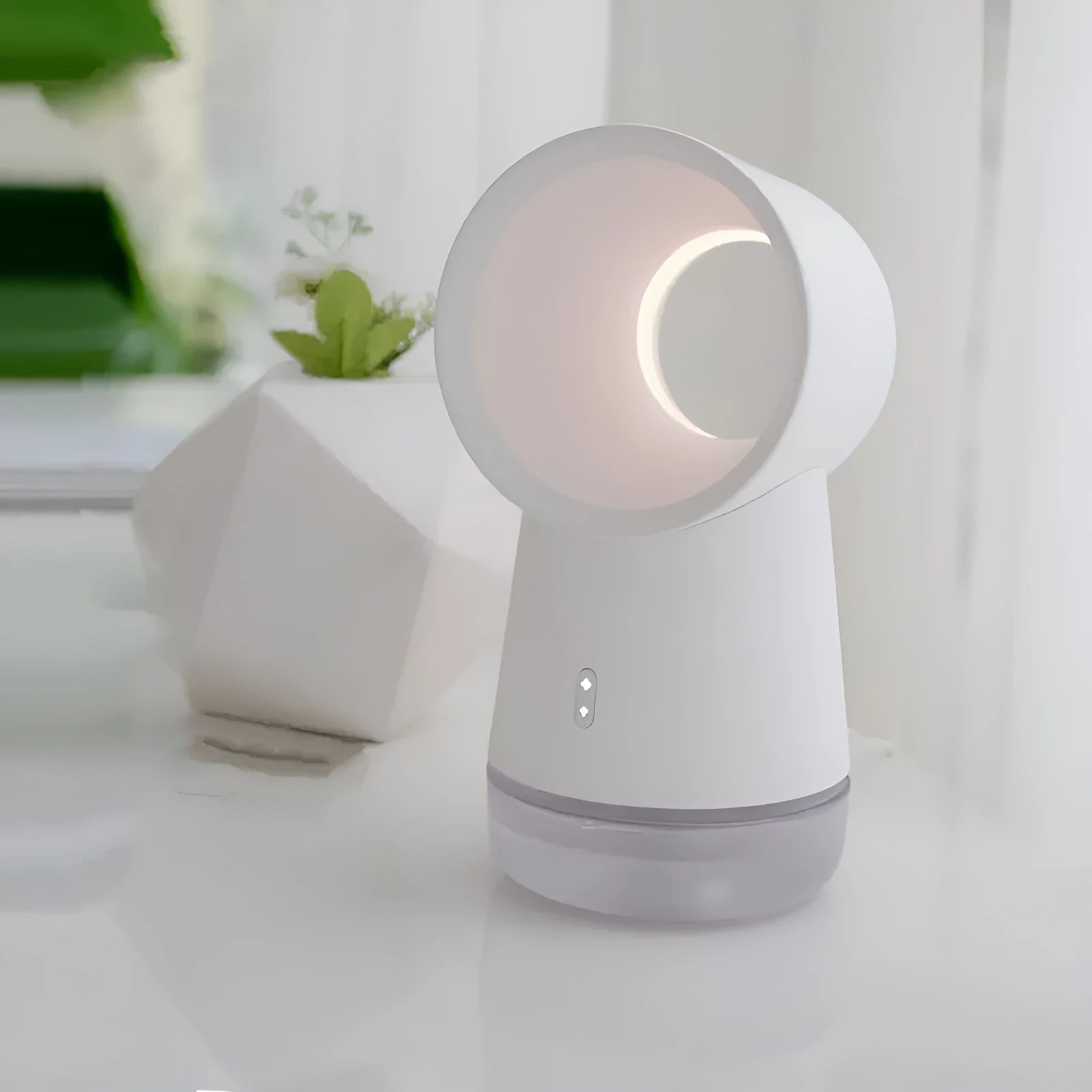 White desktop humidifier with leafless fan and 300ML water tank on a desk, emitting cool mist from single fog outlet