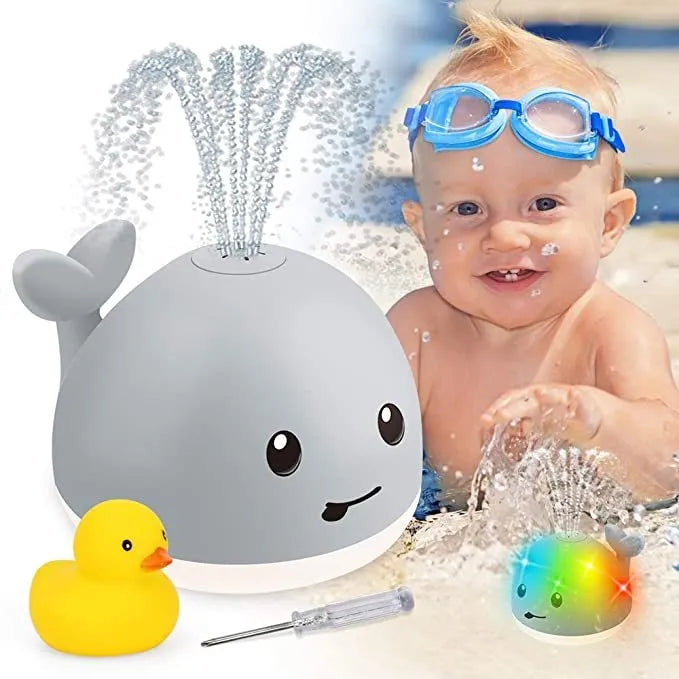 Floating grey and white whale bath toy spraying water with LED lights