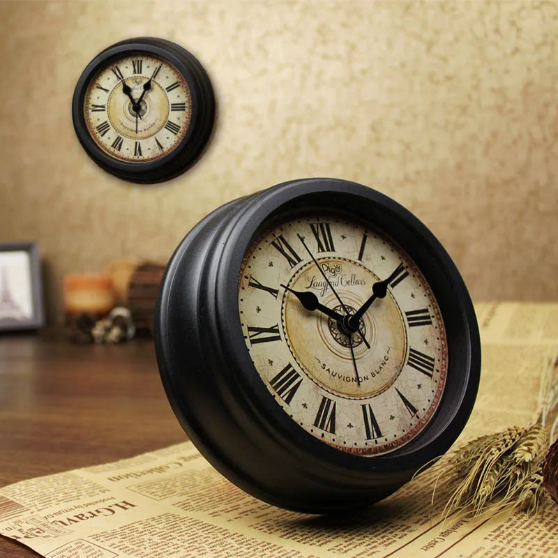 Round retro-style desk alarm clock with a white dial and silent sweep movement on a wooden surface.