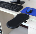 Black plastic rotating computer hand bracket wrist pad showing 180-degree adjustment on a desk.