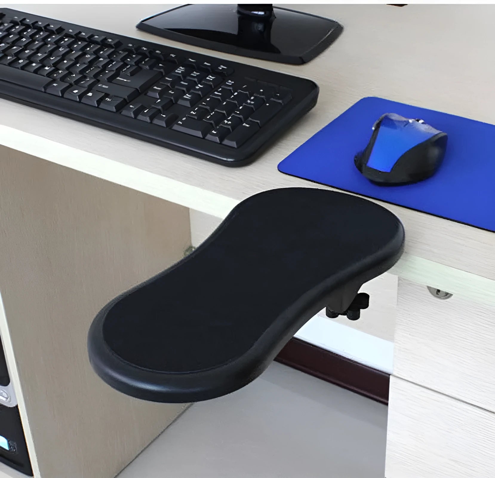 Black plastic rotating computer hand bracket wrist pad showing 180-degree adjustment on a desk.