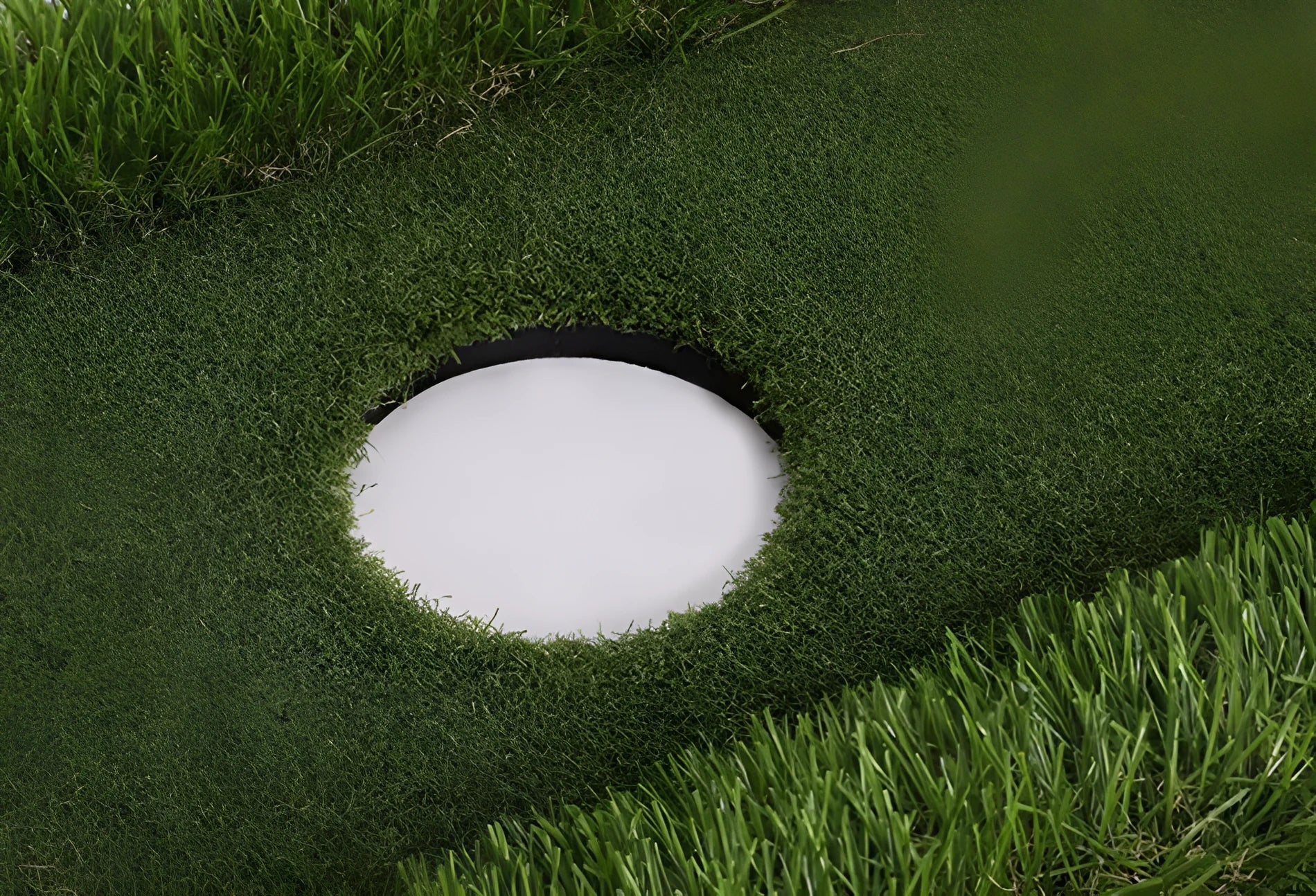 Green golf training mat on flat surface showing polypropylene grass texture and EVA foam base