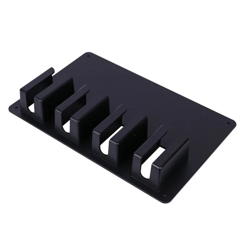 Black plastic wall-mounted storage rack holding four electric hair clippers for salon or home organisation