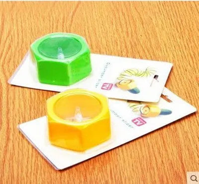 Yellow and green plastic spiral vegetable cutter for slicing cucumber, 8cm in diameter.