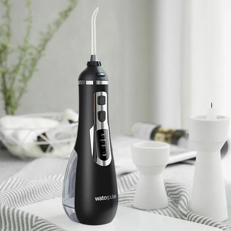 V500 portable electric dental flusher in white with black carrying case on bathroom counter