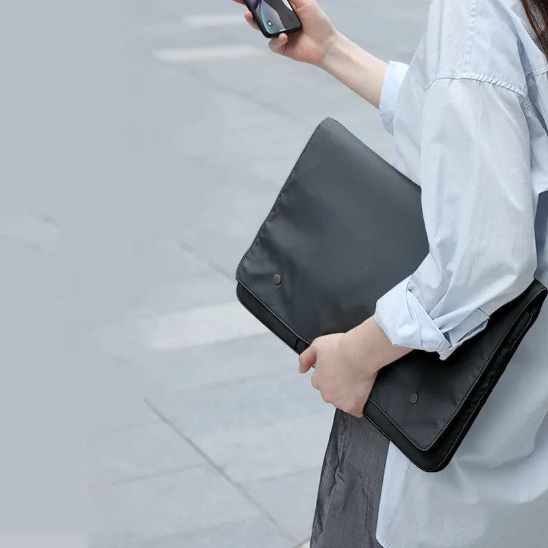 Black nylon notebook liner bag with magnetic buckle and internal pockets for 13-inch laptop