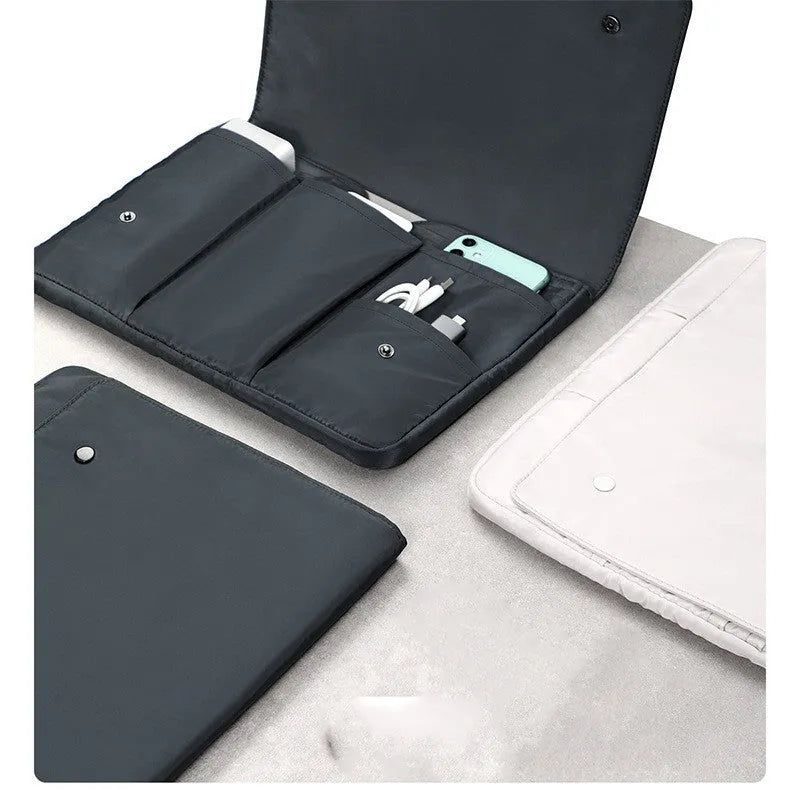 Black nylon notebook liner bag with magnetic buckle and internal pockets for 13-inch laptop