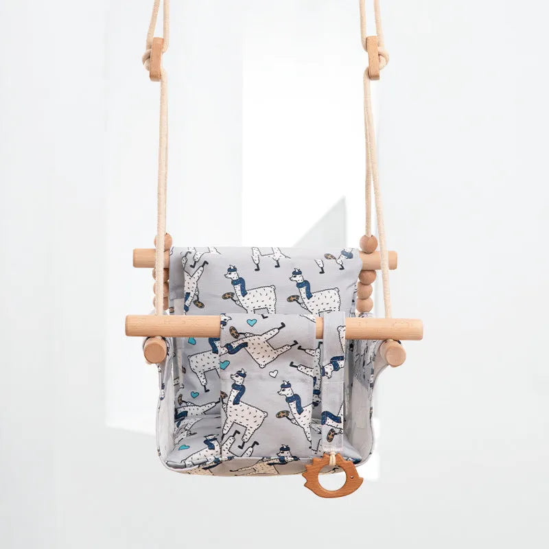 Cotton canvas baby swing chair with wooden seat and colourful tassel, hanging indoors.