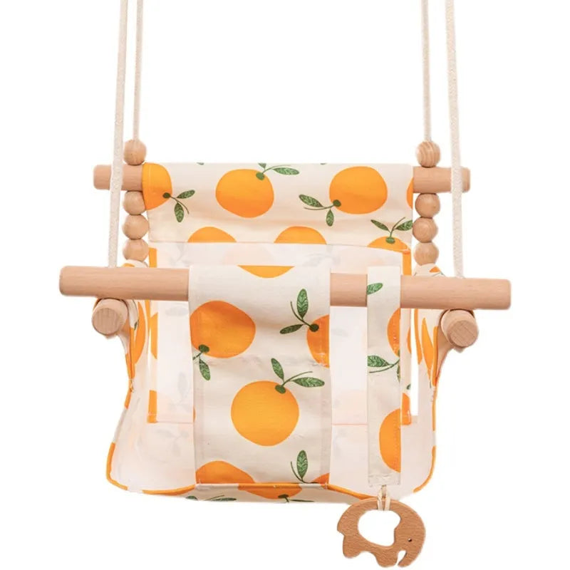 Cotton canvas baby swing chair with wooden seat and colourful tassel, hanging indoors.