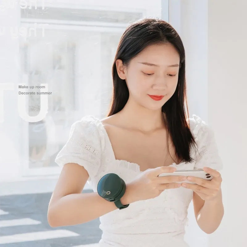 Portable leafless wrist fan with mirror, USB rechargeable, three speed settings, 66x41mm, in white on a table