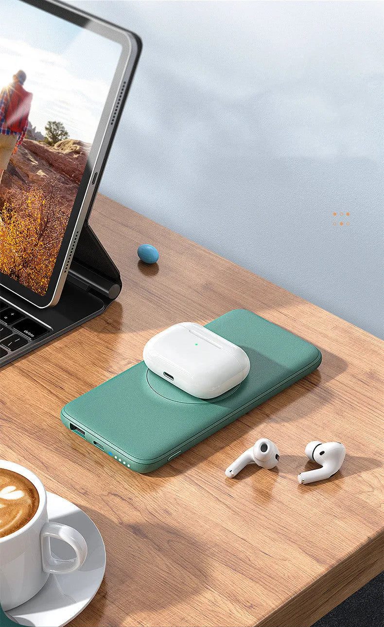 Mint green Maiduo MagSafe magnetic wireless power bank attached to the back of an iPhone