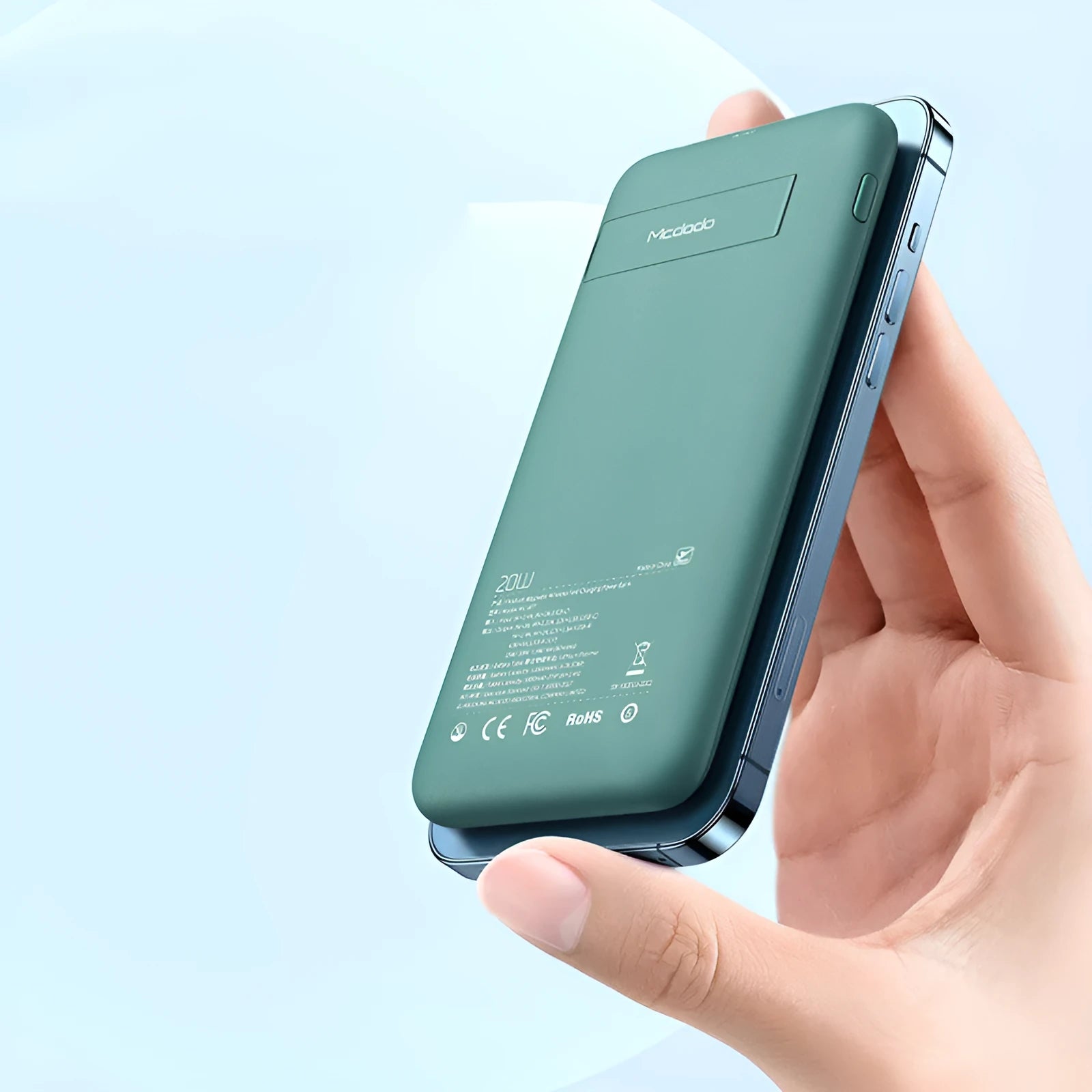 Mint green Maiduo MagSafe magnetic wireless power bank attached to the back of an iPhone