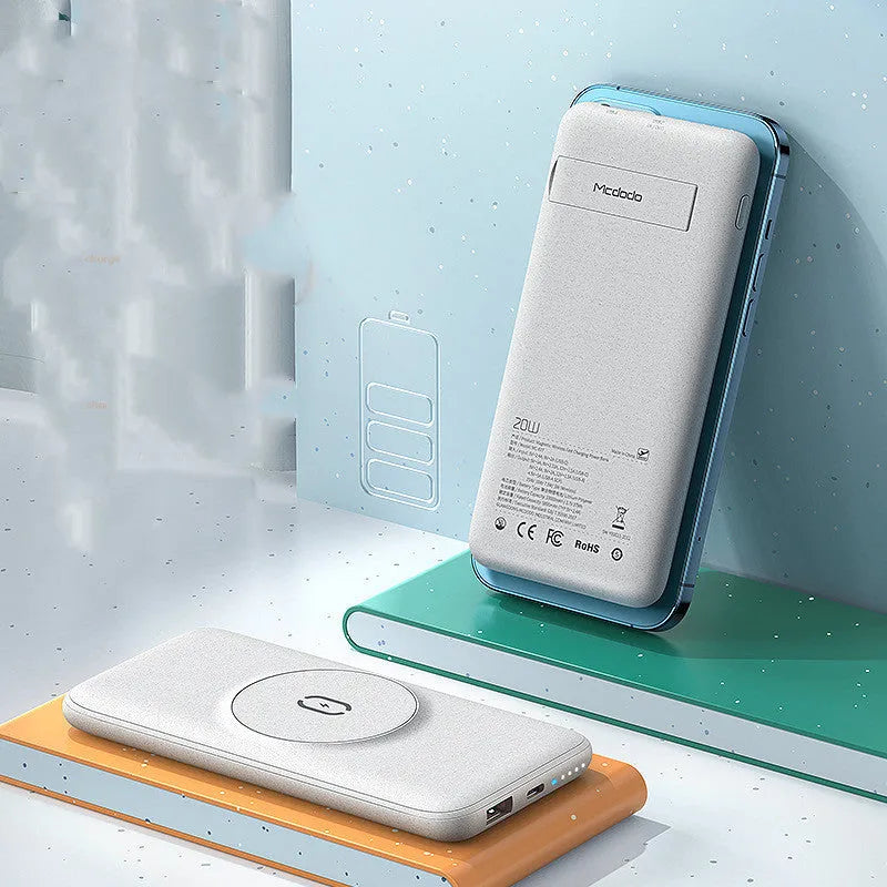 Mint green Maiduo MagSafe magnetic wireless power bank attached to the back of an iPhone