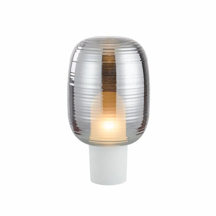 Simple Nordic style glass table lamp and matching chandelier in cognac and smoky grey colours.