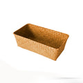 Natural straw desktop storage organiser box with woven lid in brown colour on a desk