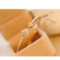 Alloy flower bracelet in gold finish with adjustable chain and flower pendant