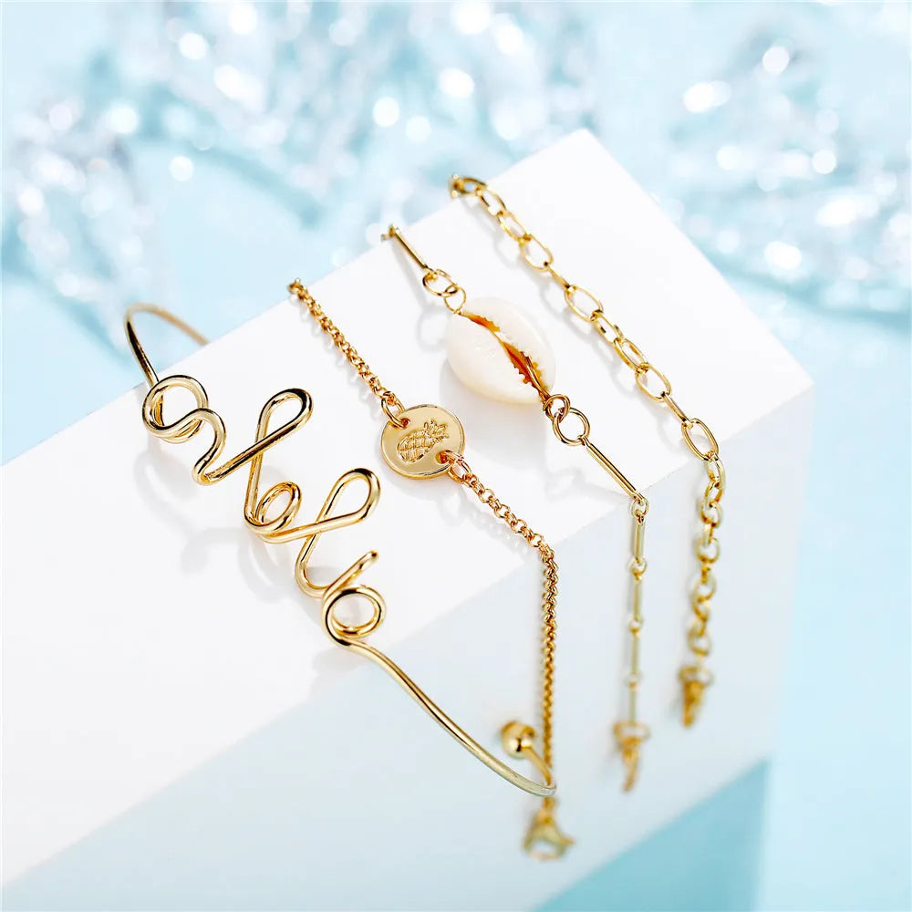 Set of four alloy bracelets in multicolour designs arranged in a gift box