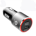 Compact dual-port 83W fast car charger plugged into a vehicle's 12V socket with USB-C and USB-A cables connected.