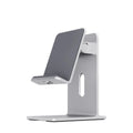 Dark space grey alloy mobile phone holder on a desk supporting a smartphone.