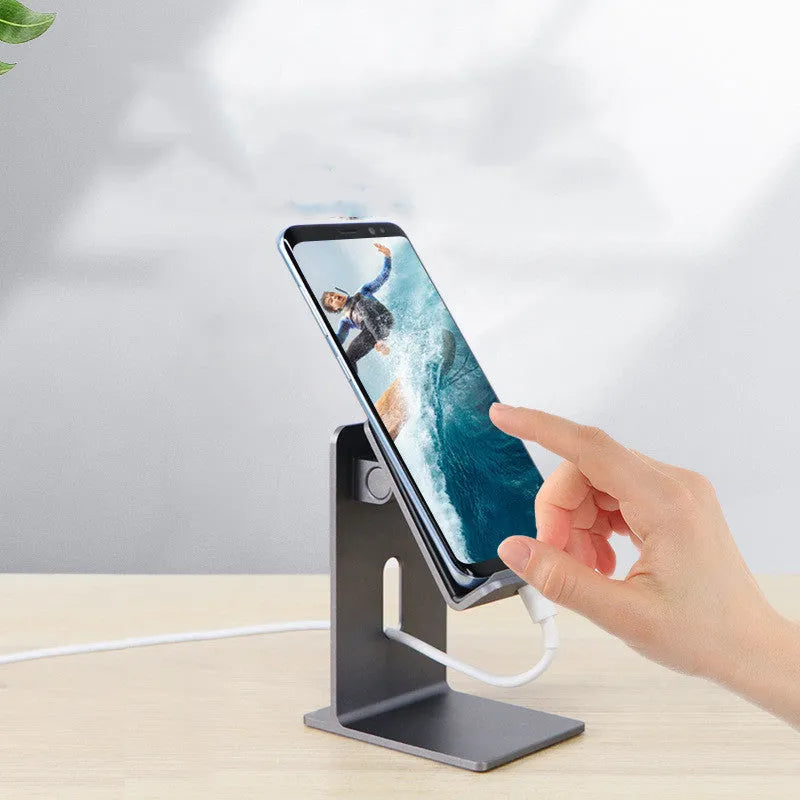 Dark Space Gray aluminium alloy adjustable lazy bracket phone holder clamped to a desk edge, holding a mobile phone.