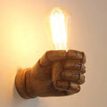 Resin wall lamp shaped like a clenched fist in black, white, or wood grain finish for bar or corridor decoration.