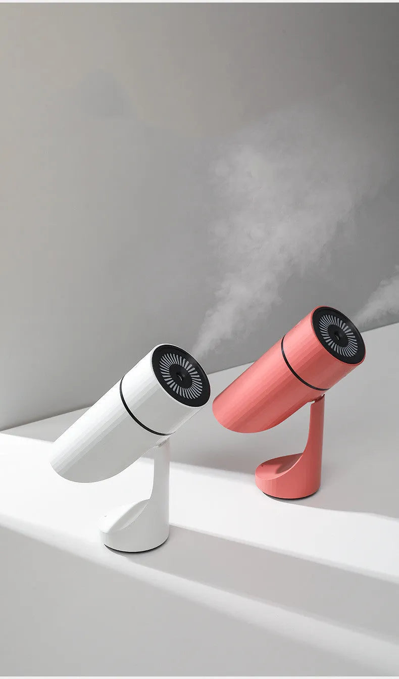 White USB small car desktop humidifier with adjustable angle nozzle and colourful night light on a desk