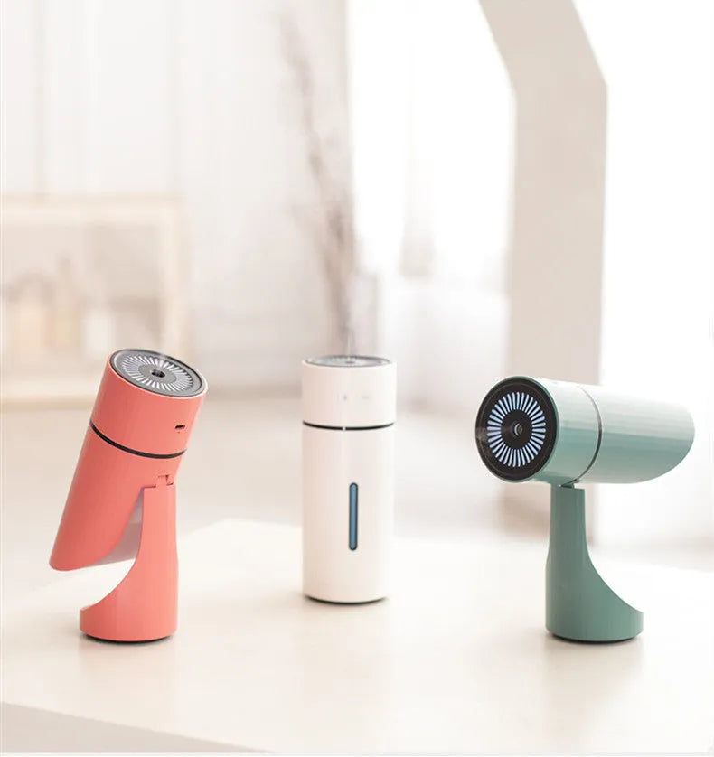White USB small car desktop humidifier with adjustable angle nozzle and colourful night light on a desk
