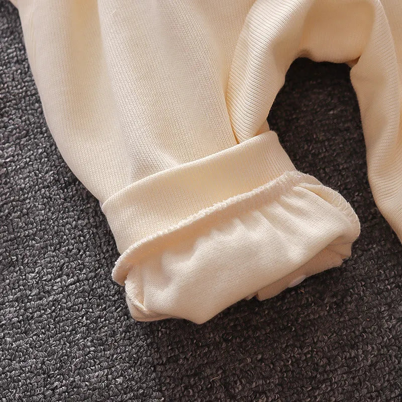 Baby elephant two-piece suit in creamy white with long sleeves, snap button crotch, and round neck design on soft cotton fabric.