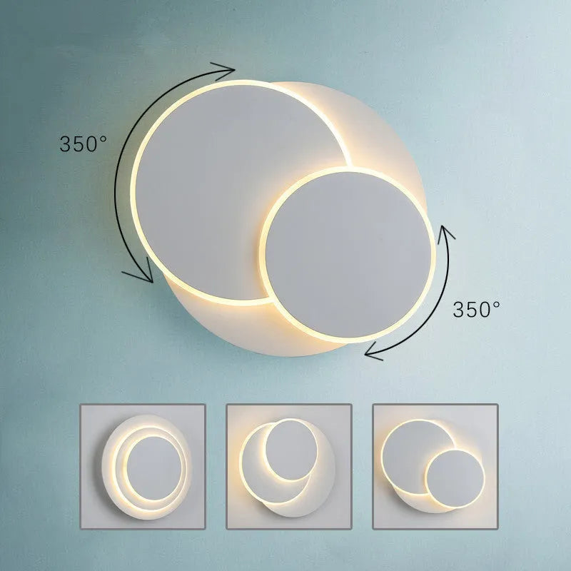 Modern round acrylic wall lamp in black and white, shown in small, medium, and large sizes.
