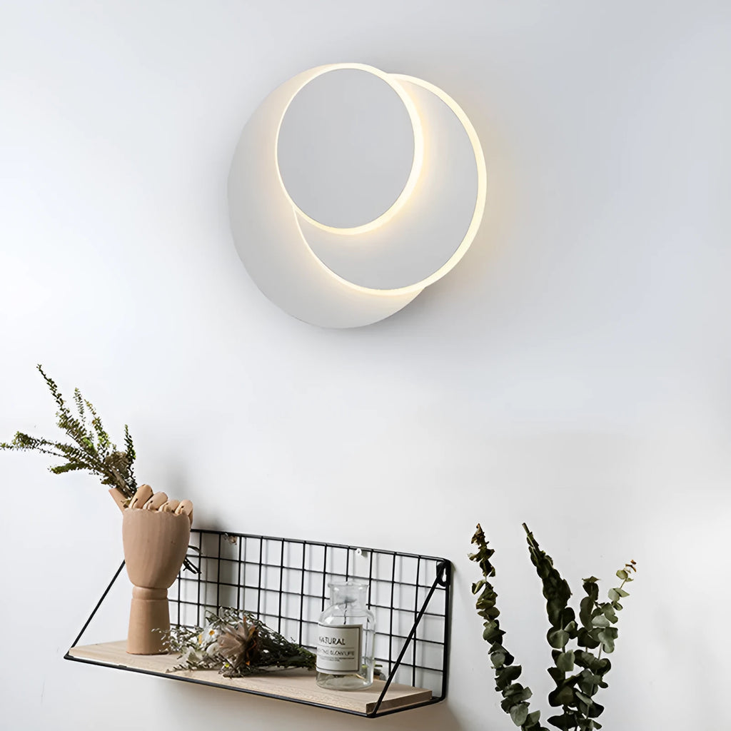 Modern round acrylic wall lamp in black and white, shown in small, medium, and large sizes.