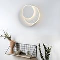 Modern round acrylic wall lamp in black and white, shown in small, medium, and large sizes.
