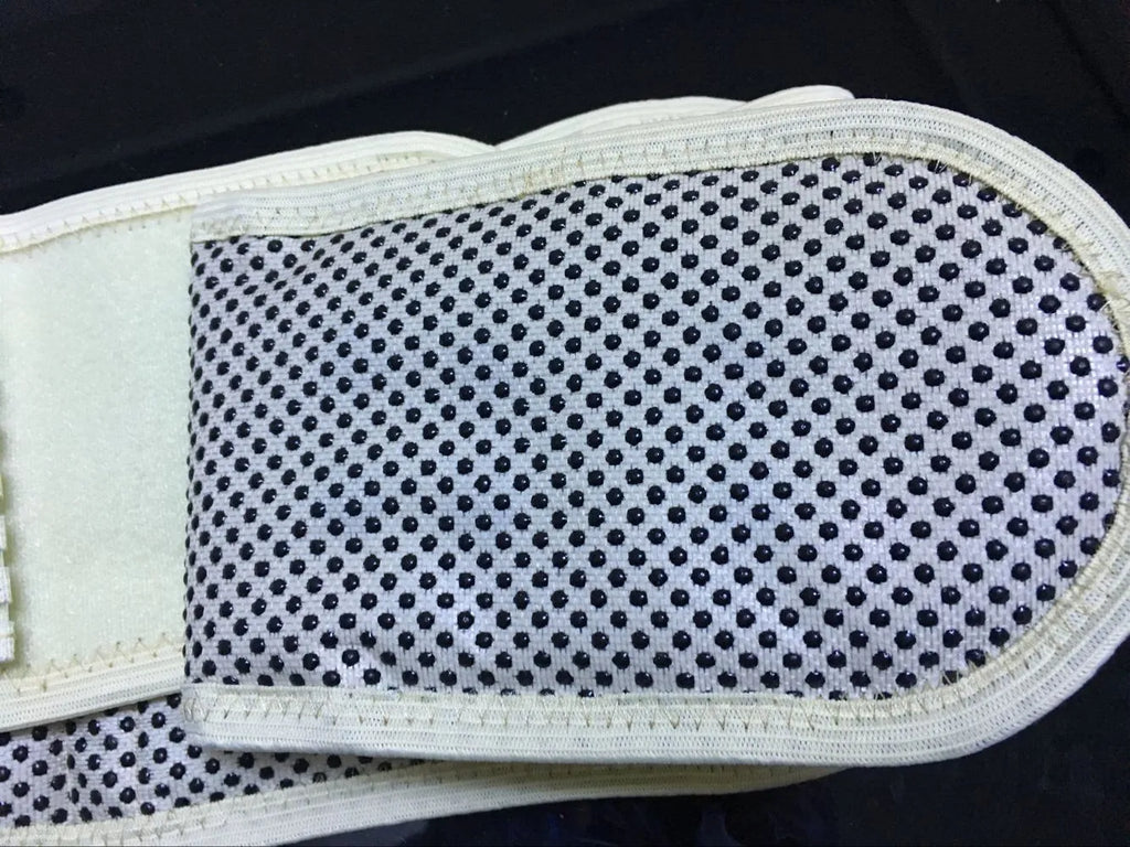 Beige self-heating waist belt with magnetic therapy, adjustable for lumbar support on mannequin.
