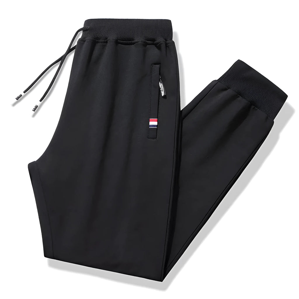Pair of 95% cotton drawstring trousers in light grey, straight-leg nine-tenths length, laid flat on a plain background