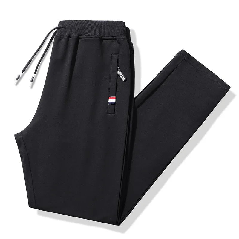Pair of 95% cotton drawstring trousers in light grey, straight-leg nine-tenths length, laid flat on a plain background