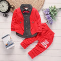 Toddler boy wearing a grey printed casual suit set with jacket and trousers.