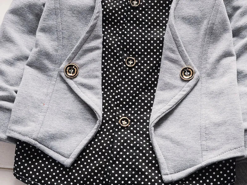 Toddler boy wearing a grey printed casual suit set with jacket and trousers.
