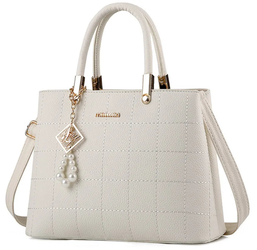 Medium women's PU handbag with zip top, soft handle, car suture detail, and horizontal square shape