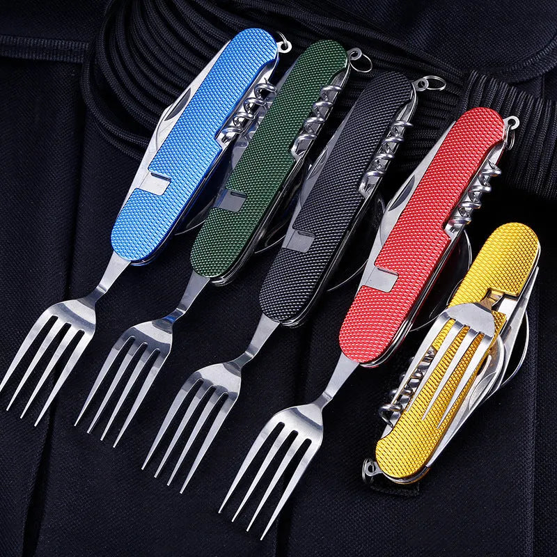 Multifunctional stainless steel outdoor camping knife fork spoon set folded and unfolded on a wooden table
