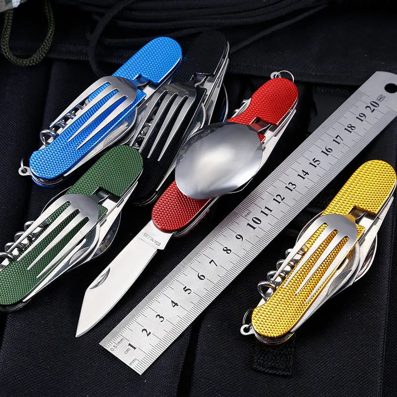 Multifunctional stainless steel outdoor camping knife fork spoon set folded and unfolded on a wooden table
