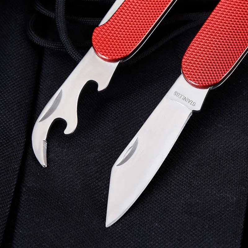 Multifunctional stainless steel outdoor camping knife fork spoon set folded and unfolded on a wooden table