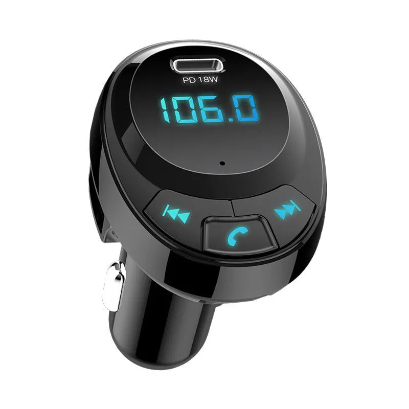 Black Bluetooth car MP3 charger with numeric display plugged into a car dashboard cigarette lighter.