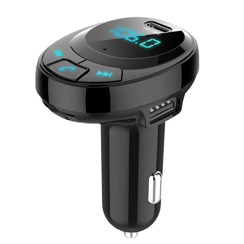 Black Bluetooth car MP3 charger with numeric display plugged into a car dashboard cigarette lighter.