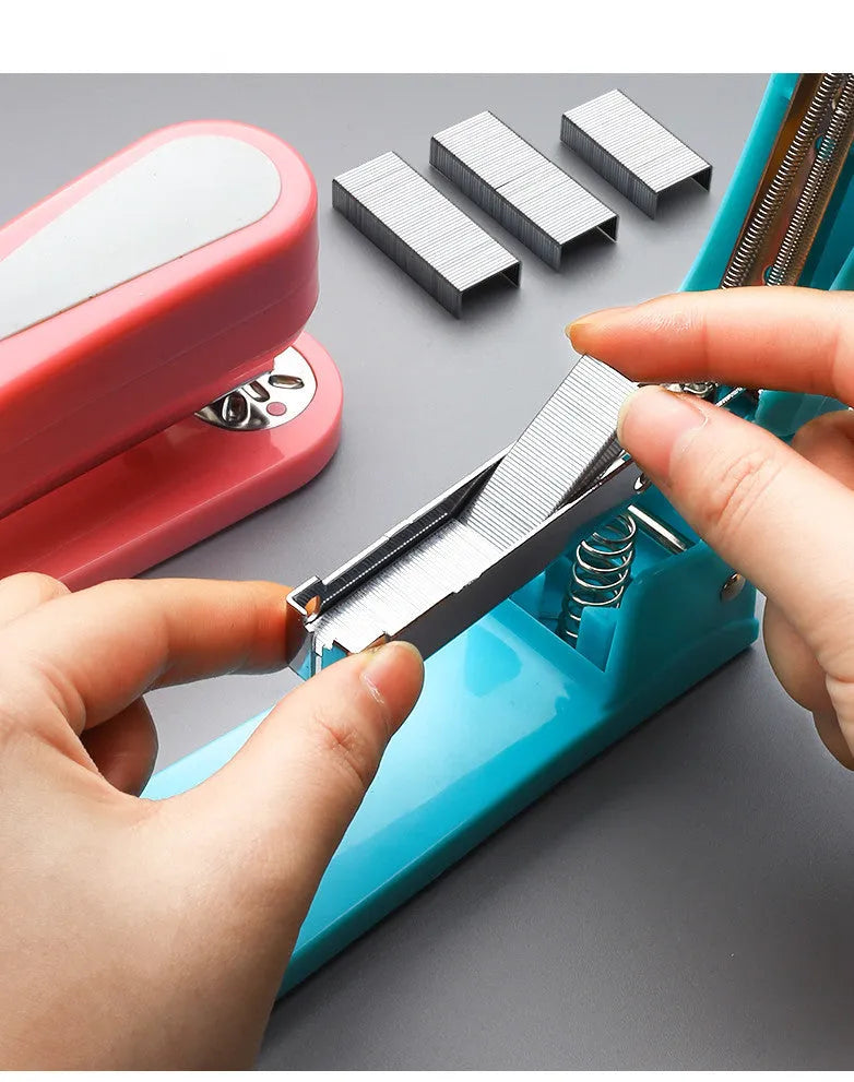 360-degree rotatable desktop stapler in dark blue, shown binding sheets of A4 paper.