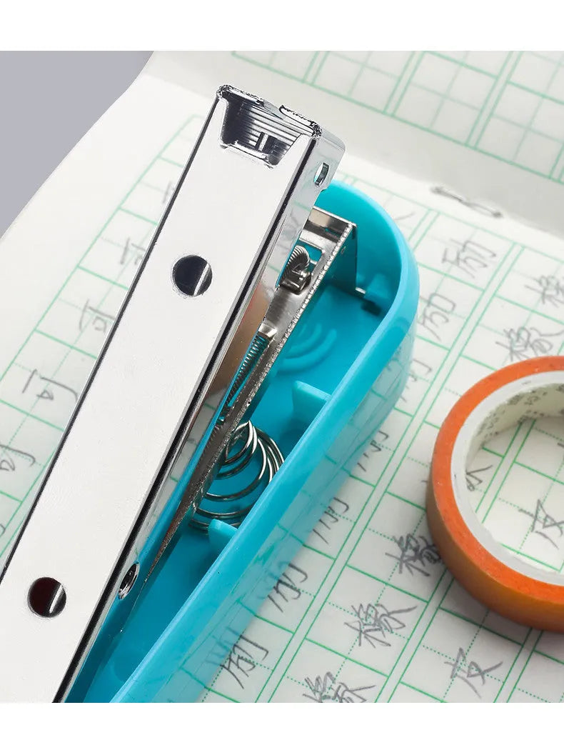 360-degree rotatable desktop stapler in dark blue, shown binding sheets of A4 paper.