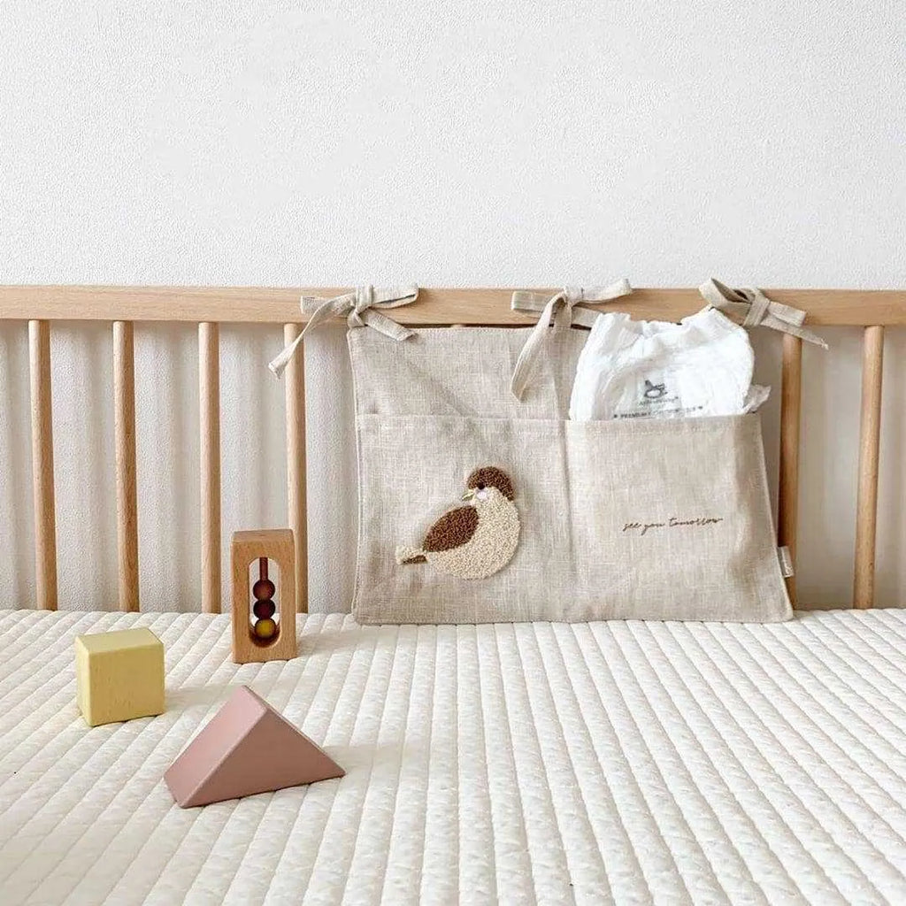 Khaki coloured cotton linen hanging storage bag with one pocket, designed for bedside organisation.